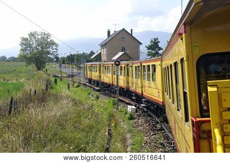 Latour De Carol - September 4, 2018: The Small Yellow Train Of The Pyrenees Crossing A Beautiful Mou