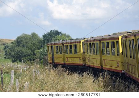 Latour De Carol - September 4, 2018: The Small Yellow Train Of The Pyrenees Crossing A Beautiful Mou