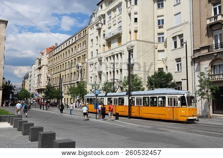 Budapest, Hungary - June 19, 2014: People Ride Orange Tram In Budapest. It Is Part Of Bkk Public Tra
