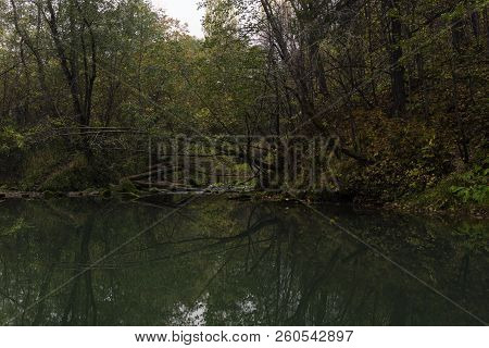 Deep Lost Forest Karst Lake In The Autumn Dusk