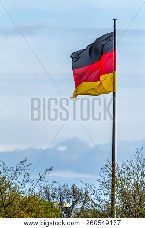 Federal Republic Of Germany, German National Flag Waving On The Blue Sky Background