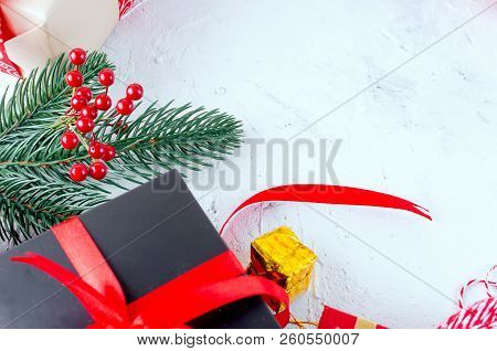 Christmas Decorative Background With Fir Branches, Cones, Redr And Black Christmas  Gifts, Ball On T