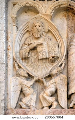 MODENA, ITALY - JUNE 04: Creation Of Adam and Eve, God the Father relief by Wiligelmo, Modena Cathedral, Italy on June 04, 2017.
