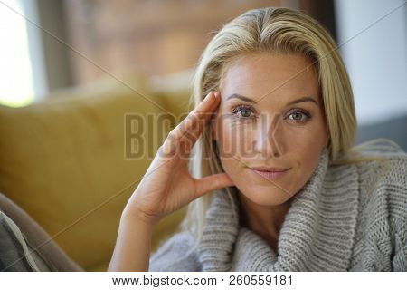 Portrait of 40-year-old woman with woolen sweater