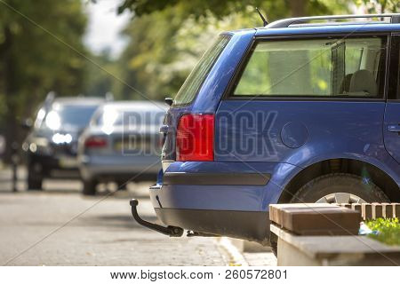 Close-up View Detail Of Blue Car Parked On Sunny Street, Red Stop Lights And Hook For Dragging Trail