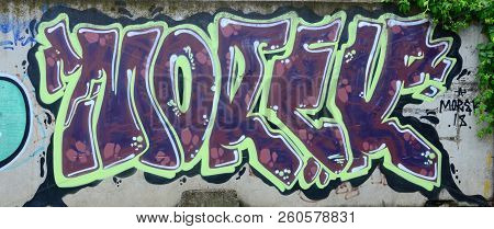 Full And Acomplished Graffiti Artwork. The Old Wall Decorated With Paint Stains In The Style Of Stre