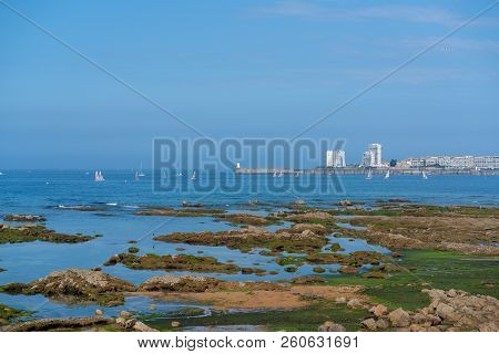 Lighthouse On Jetty With Sailing Boat And Rocks In Les Sables D Olonne In Vendee France