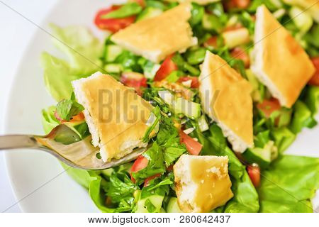 Bite Of Lebanese Fattoush Or Bread Salad On A Fork - Fresh And Delicious Vegan Meal With Pita Bread