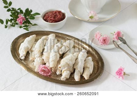 Traditional Romanian Or Moldavian Shortcake Cookies With Jam Stuffing And A Cup Of Tea On The Light 