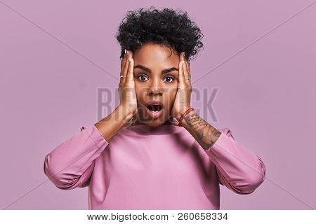 Young Lovely Dark Skinned Female Has Curly Hair, Looks Surprisingly At Camera, Keeps Jaw Dropped, Wo
