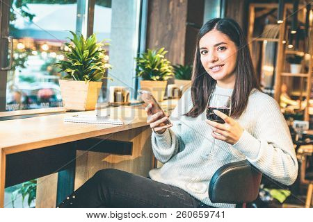 Christmas Concept - Happy Young Woman With Glass Of Wine Or Glintwine Checking The Phone