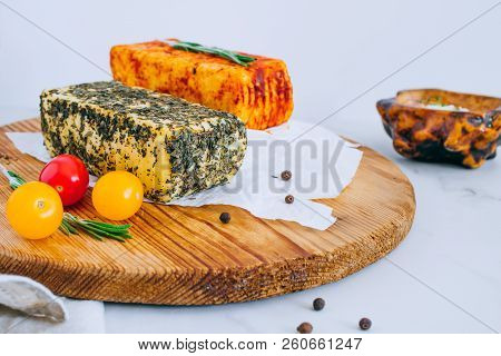 Cheese Halumi With Mint And Smoked Paprika On A Wooden Board With Tomatoes, Pepper And Rosemary