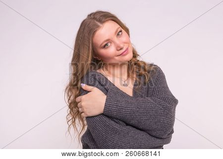 Close Up Portrait Of Caucasian Tender Woman With Curly Hair Wearing Gray Cardigan On White Backgroun