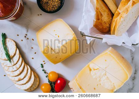 Cachotta Cheese With With Fenugreek, Jam, Baguette, Crackers, Rosemary And Thyme On Marble