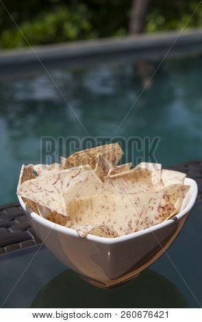White Dish Of Malanga Chips By The Swimming Pool