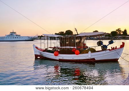 Sunset Scenery At Eretria Euboea Greece - Traditional Wooden Fishing Boat In The Sea