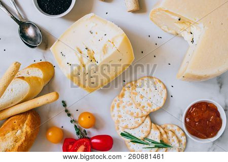 Cachotta Cheese With With Fenugreek, Jam, Baguette, Crackers, Rosemary And Thyme On Marble