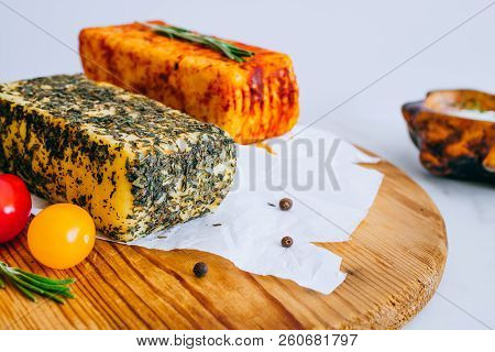 Cheese Halumi With Mint And Smoked Paprika On A Wooden Board With Tomatoes, Pepper And Rosemary