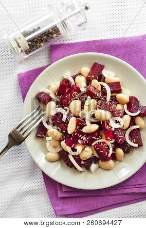 Beetroot Salad With White Kidney Beans, Pickles And Onion, Dressed With Oil And Flavored With Carawa