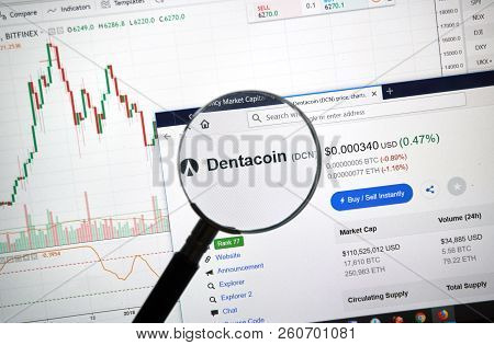 Montreal, Canada - September 8, 2018: Dentacoin Altcoin Site Under Magnifying Glass. Blockchain Is A