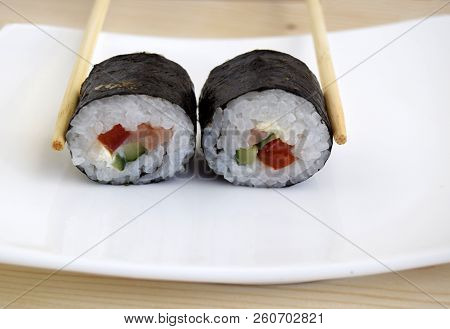 Sushi A Dish Of Traditional Japanese Cuisine Cooked From Rice, A Salmon, Vegetables And A Nori. Sush