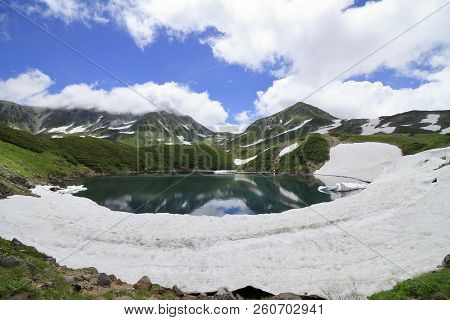 Mikurigaike Pond And Tateyama Mountain Range With Snow In Summer In Toyama, Japan