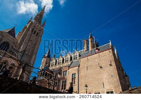 Bruges, Belgium - March, 2018: Church Of Our Lady Bruges, Bonifacius Bridge And The Building With Th