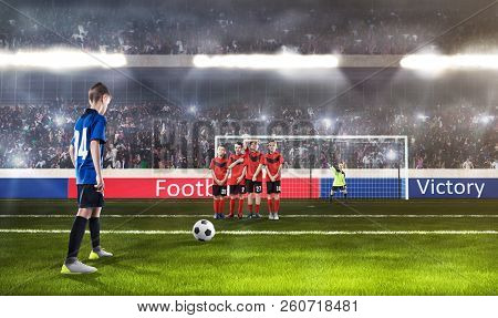 Kid Football Player Prepairing To Take A Shot On A Football Field