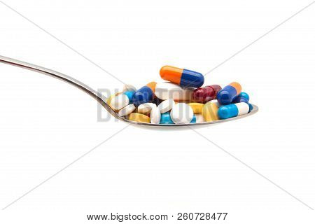 Colorful Pills And Capsule On Spoon On White Background