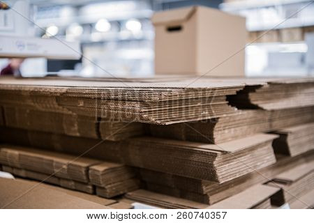 Many Non-assembled Cardboard Parcel Boxes On Stock Close Up