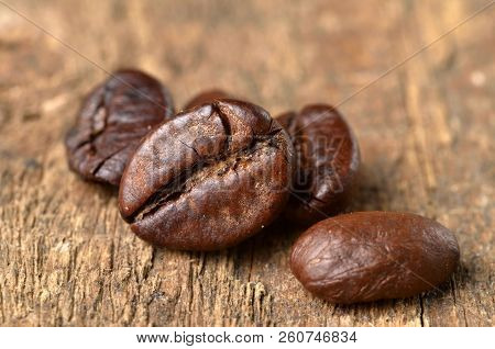 Close-up Of Coffee Beans On A Wooden Table