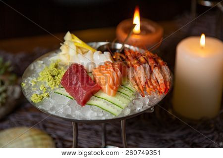 Mixed Sliced Fish Sashimi And Shrimps On Ice In Black Bowl. Sashimi Salmon Tuna Hamachi Prawn And Su