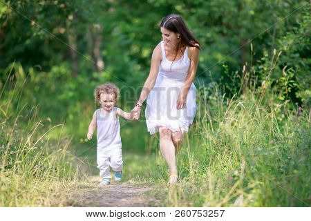 Mother And Son Having Fun Running And Playing Together At The Patk.