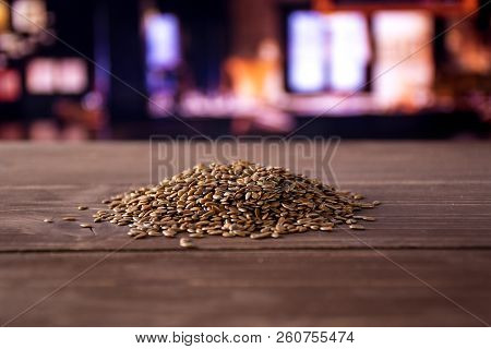 Lot Of Whole Fresh Brown Flaxseeds Heap With Restaurant In Background