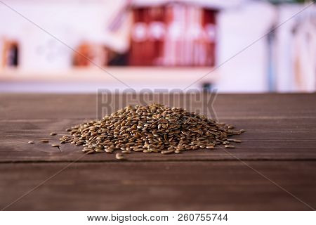 Lot Of Whole Fresh Brown Flaxseeds Heap With Grey Kitchen In Background