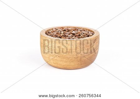 Lot Of Whole Fresh Brown Flaxseeds With Wooden Bowl Isolated On White Background