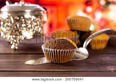 One Whole Fresh Baked Marble Muffin On Silver Cake Server With Christmas Tree In Red Background