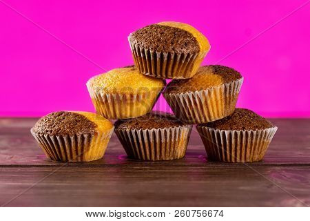Set Of Six Whole Fresh Baked Marble Muffin With Pink In Background