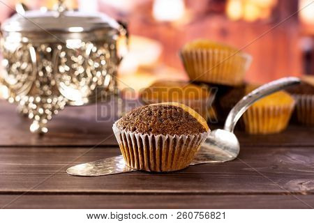 One Whole Fresh Baked Marble Muffin On Silver Cake Server With Rustic Wood Kitchen In Background