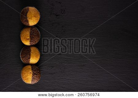 Group Of Four Whole Fresh Baked Marble Muffin Flatlay On Grey Stone