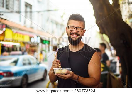 Foreigner Eating Baozi On The Street In China