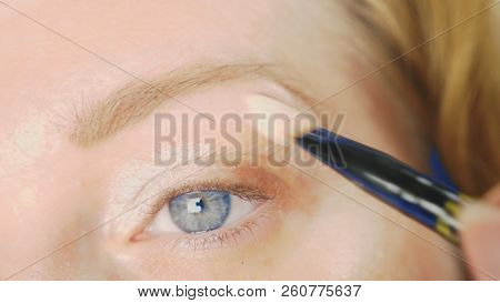 Super Close-up, A Woman Doing Her Eye Make-up, Paints The Eyelid With Shadows.