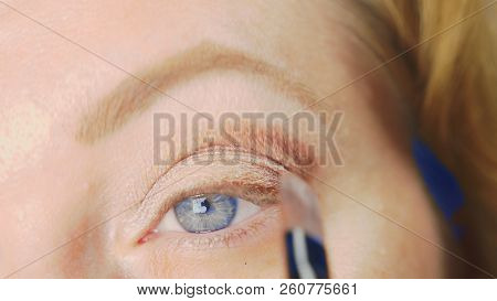 Super Close-up, A Woman Doing Her Eye Make-up, Paints The Eyelid With Shadows.