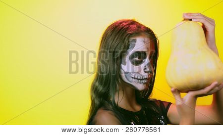 Halloween, Girl With Make-up Skeleton On Half Face, Dressed As Witch, Posing On Bright Yellow Backgr