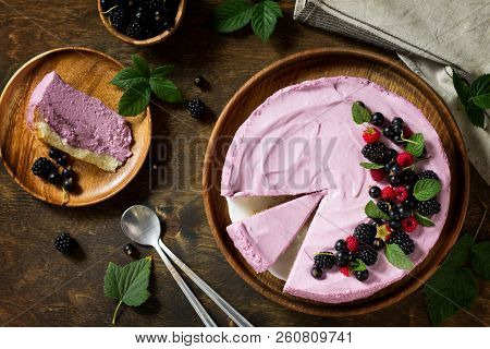 Cake With Black Currant Cream Souffle And Biscuit On A Table In A Rustic Style. Top View Flat Lay Ba