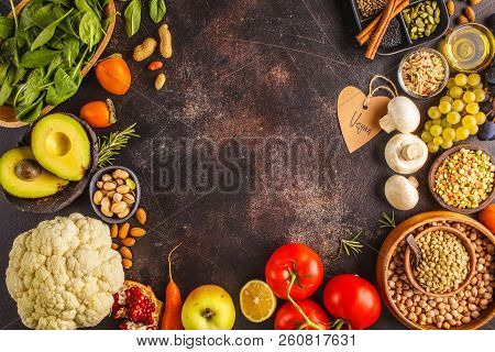 Vegan Food Ingredients On A Dark Background. Vegetables, Fruits, Cereals, Nuts, Beans Top View. Plan