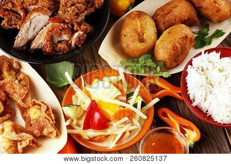 Chines Food With Fried Duck With Curry Sauce. Tom Kah Kai Soup, Dumplings And Rice. Fried Banana And