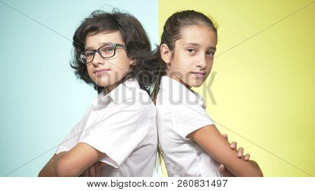 Portraits Of Children In School Uniform On A Colored Background. Funny Children. Sister And Brother.