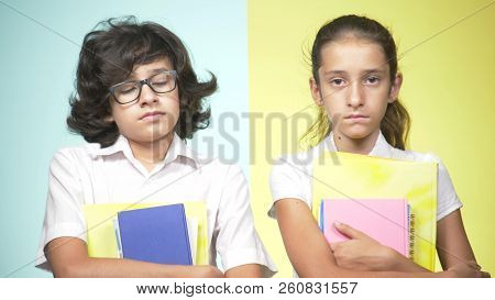 Portraits Of Children In School Uniform On A Colored Background. Funny Children. Sister And Brother.