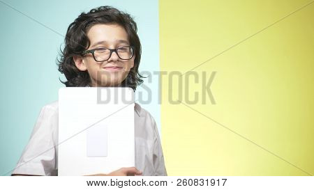 Portraits Of A Teenager In School Uniform And Glasses On A Colored Background. Funny Guy. Concept Of